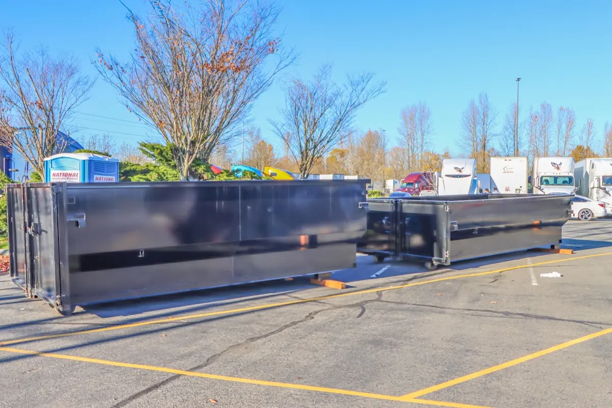 Professional dumpster rental service with roll-off container on residential driveway in Warner Robins